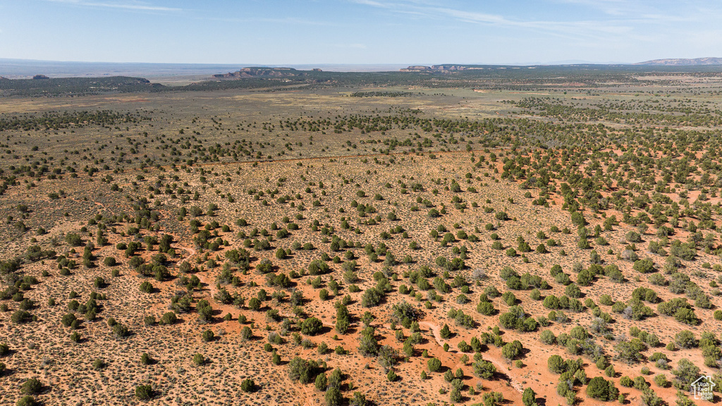 Aerial view of sparsely populated area with a mountain backdrop and a desert landscape
