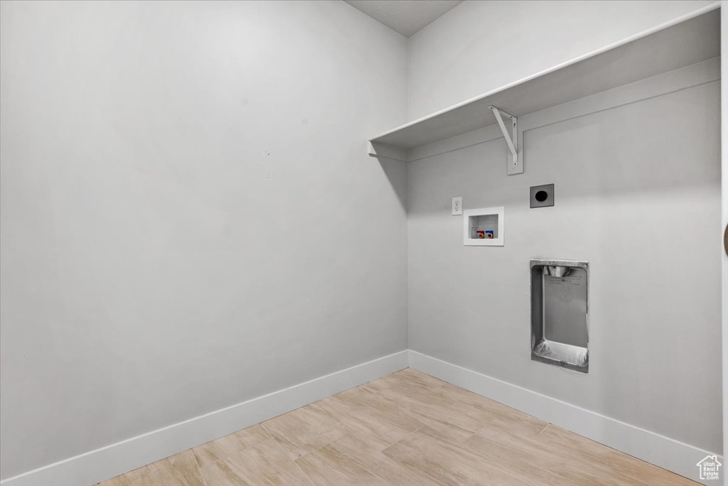 Laundry room featuring hookup for an electric dryer, hookup for a washing machine, laundry area, and baseboards