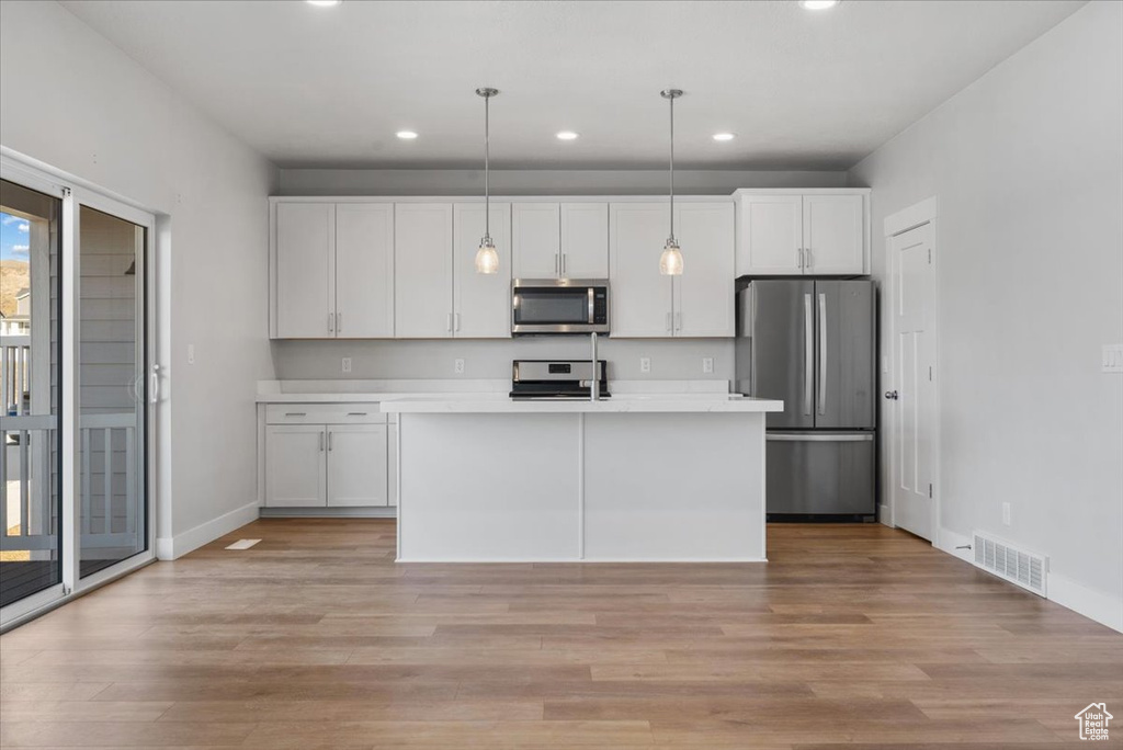 Kitchen featuring appliances with stainless steel finishes, visible vents, recessed lighting, and white cabinets