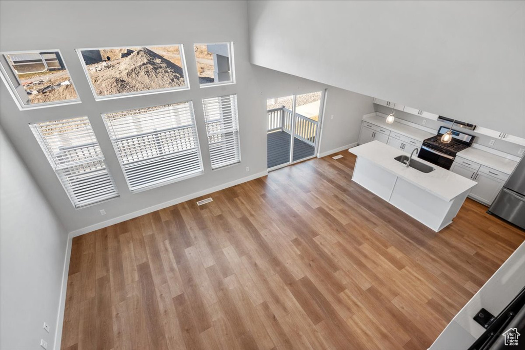 Living area with visible vents, baseboards, and light wood-style floors