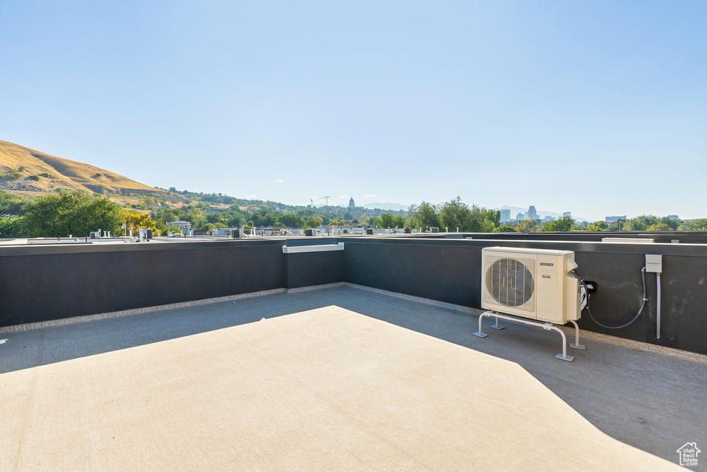 View of patio featuring a mountain view and ac unit