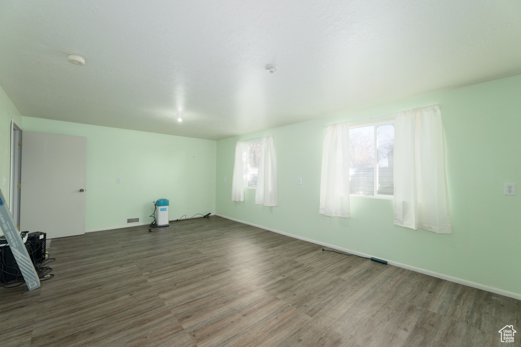 Spare room with a healthy amount of sunlight and wood-type flooring