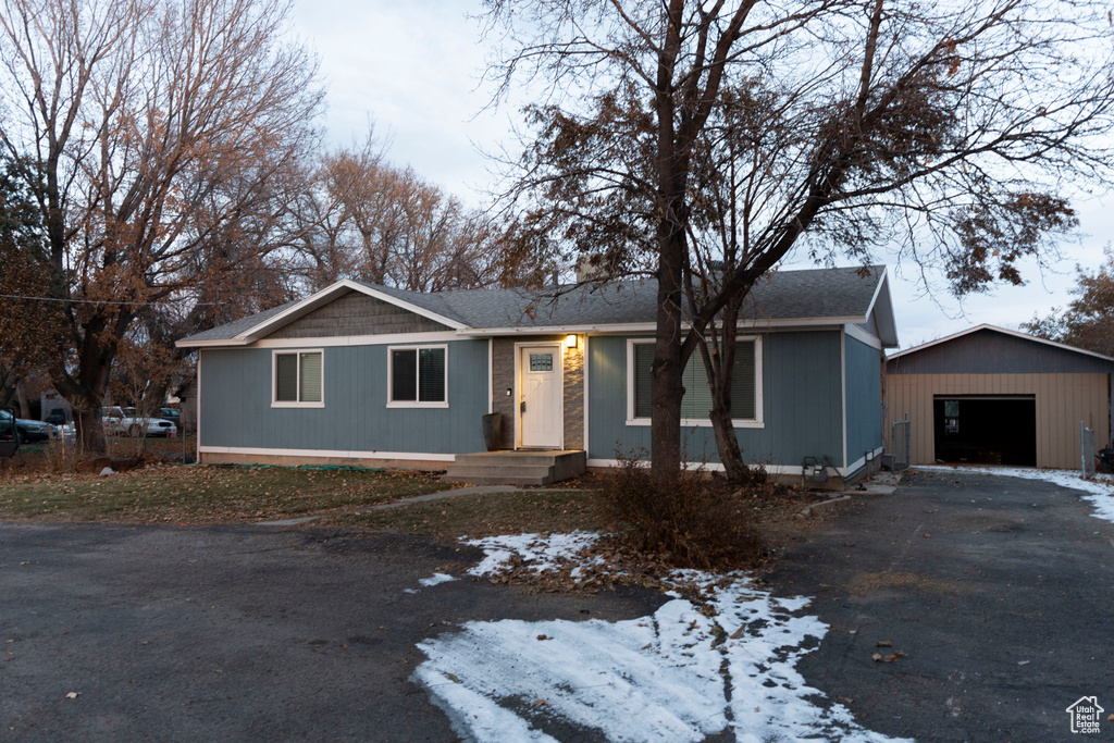 Ranch-style home with an outbuilding and a garage