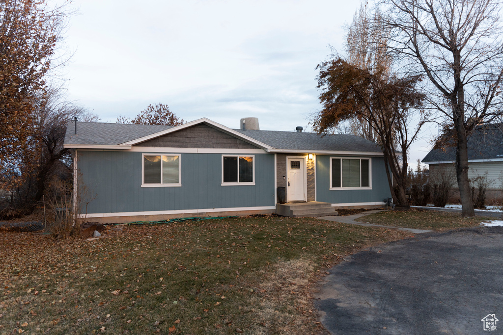 Single story home with a front lawn