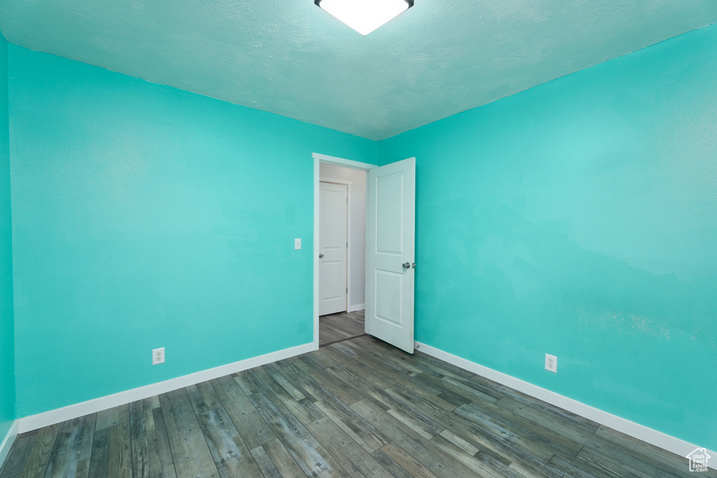 Empty room featuring hardwood / wood-style flooring
