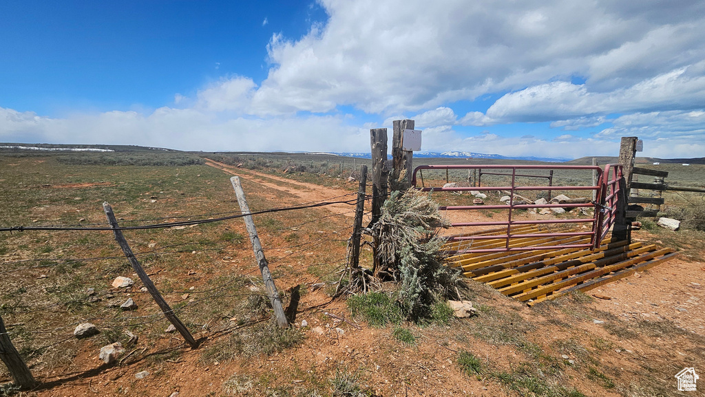 View of gate with a rural view