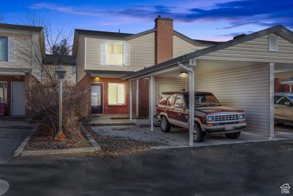 View of front of property with a carport