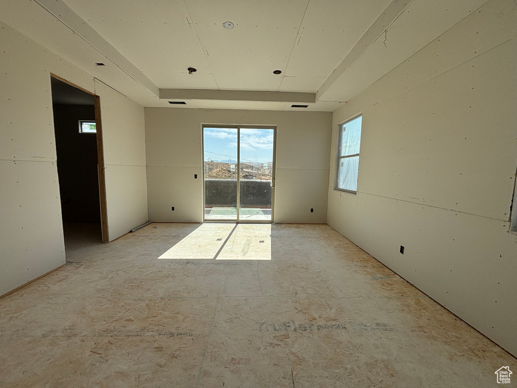 Unfurnished room with a raised ceiling