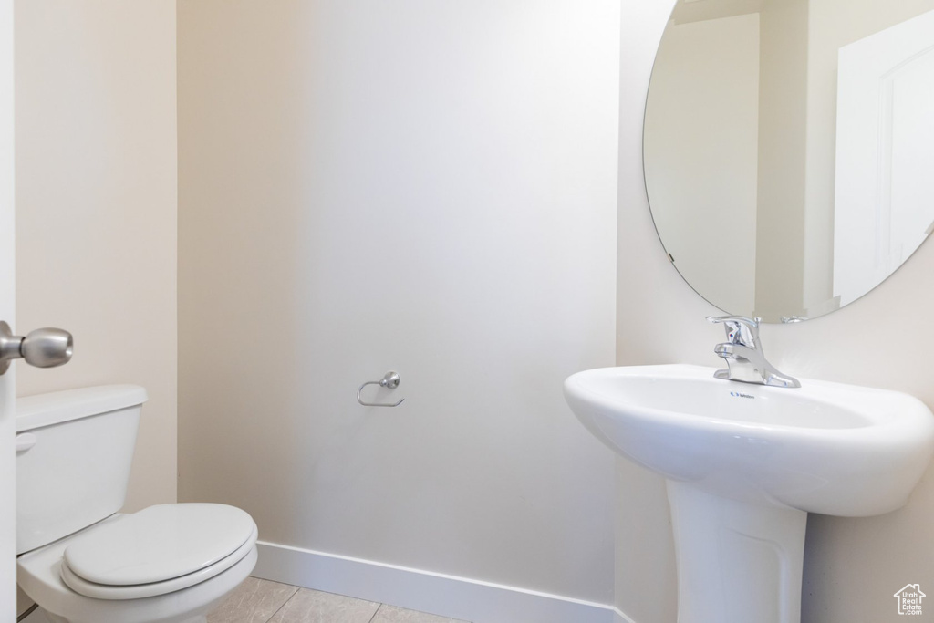 Bathroom featuring tile patterned flooring and toilet