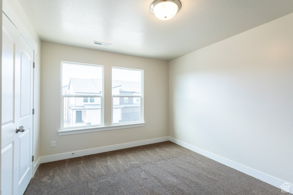Empty room with carpet flooring