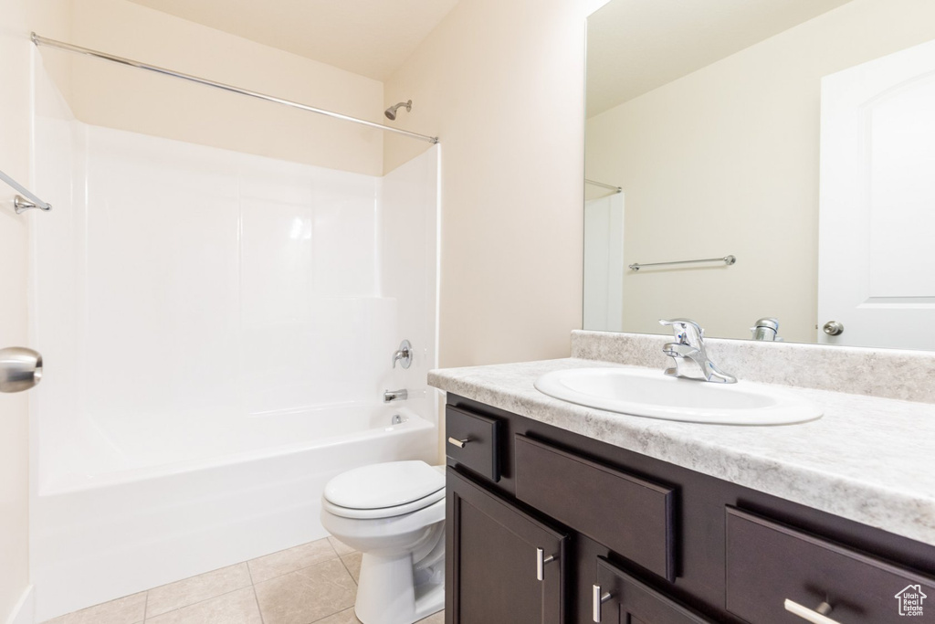 Full bathroom featuring tile patterned flooring, vanity, toilet, and washtub / shower combination