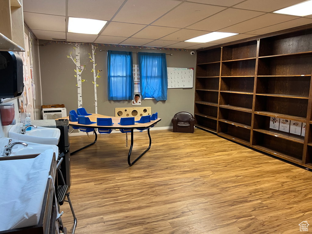 Playroom with light hardwood / wood-style floors, a drop ceiling, and sink