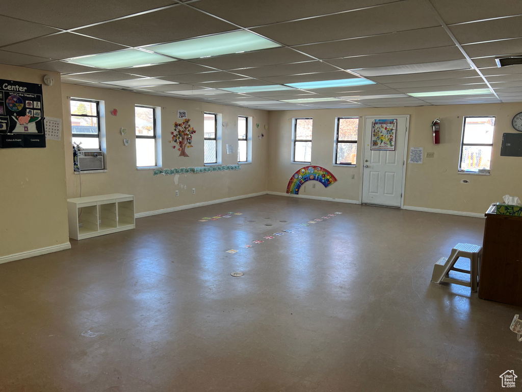 Interior space with a paneled ceiling and cooling unit