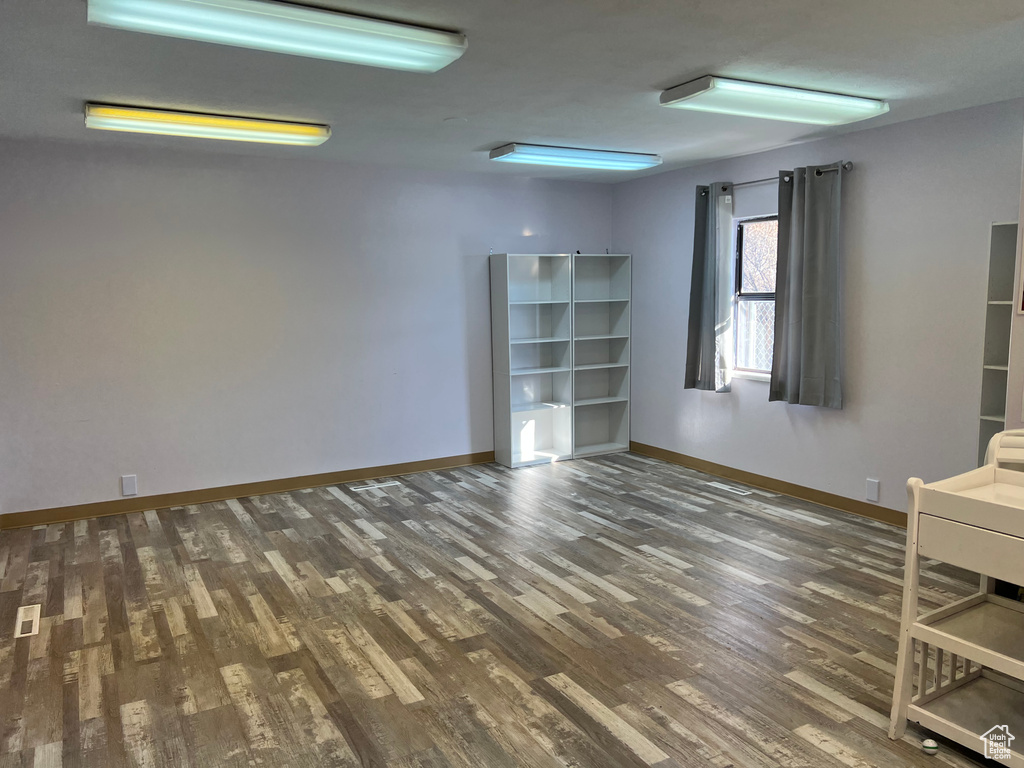 Unfurnished room with dark wood-type flooring