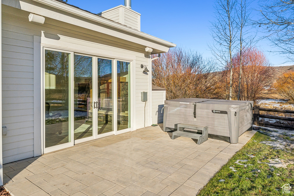 View of patio / terrace with a hot tub