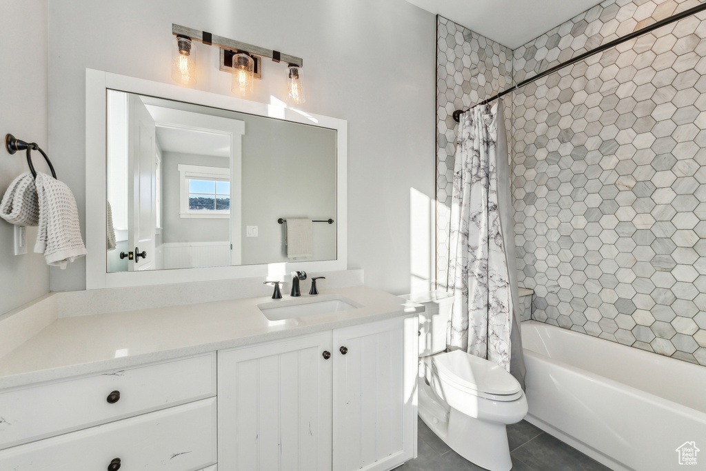 Full bathroom with tile patterned floors, vanity, toilet, and shower / tub combo
