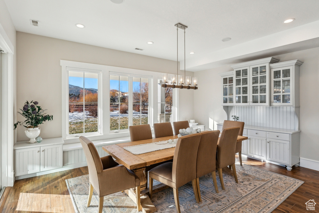 Dining area featuring dark hardwood / wood-style floors and an inviting chandelier