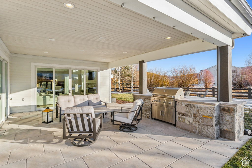 View of patio with a grill, outdoor lounge area, and exterior kitchen