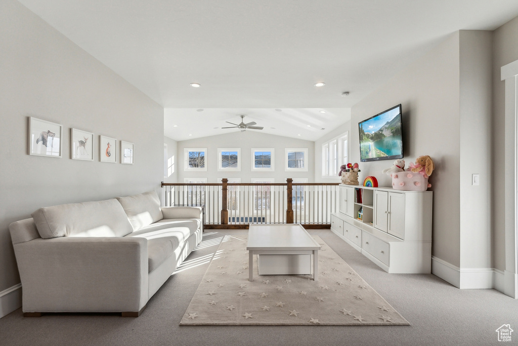 Living room with light carpet, vaulted ceiling, and ceiling fan