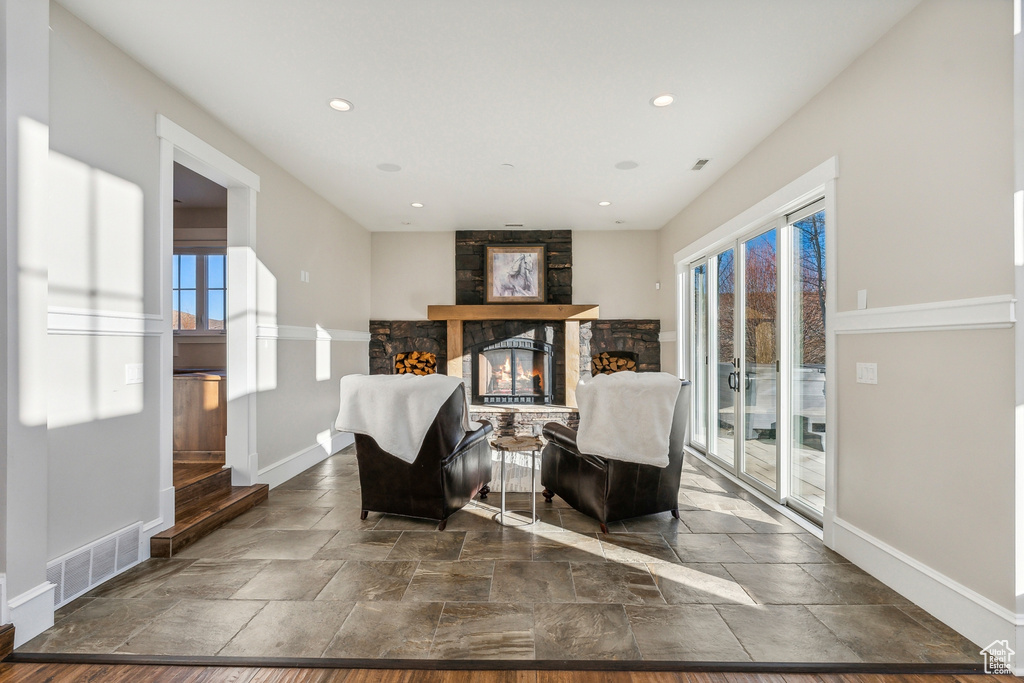 Sitting room featuring a fireplace, dark hardwood / wood-style floors, and a healthy amount of sunlight
