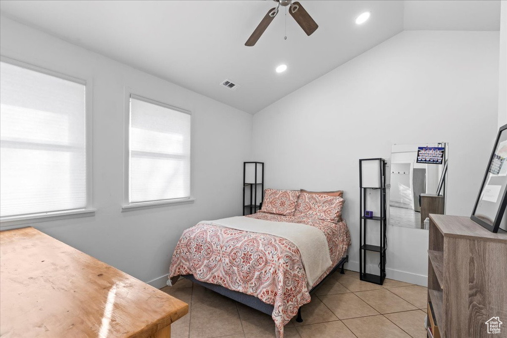 Bedroom featuring light tile patterned floors, ceiling fan, and lofted ceiling