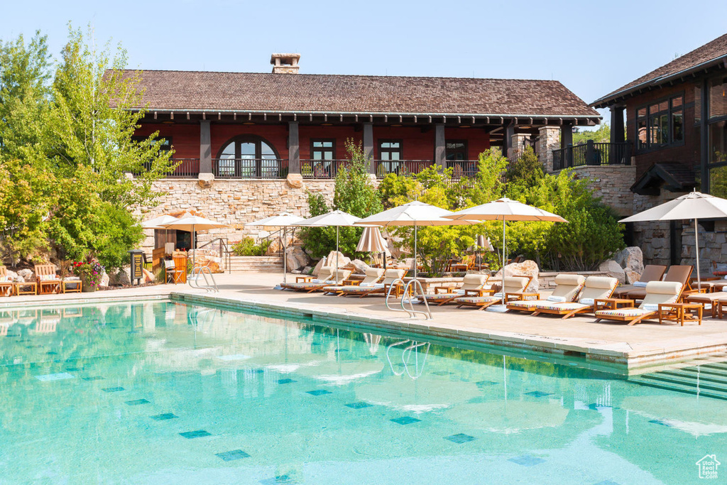 Community pool with a patio