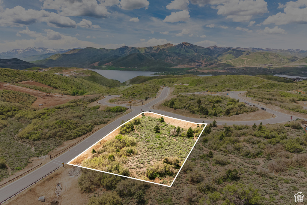 Aerial overview of property's location with a water and mountain view and property parcel outlined