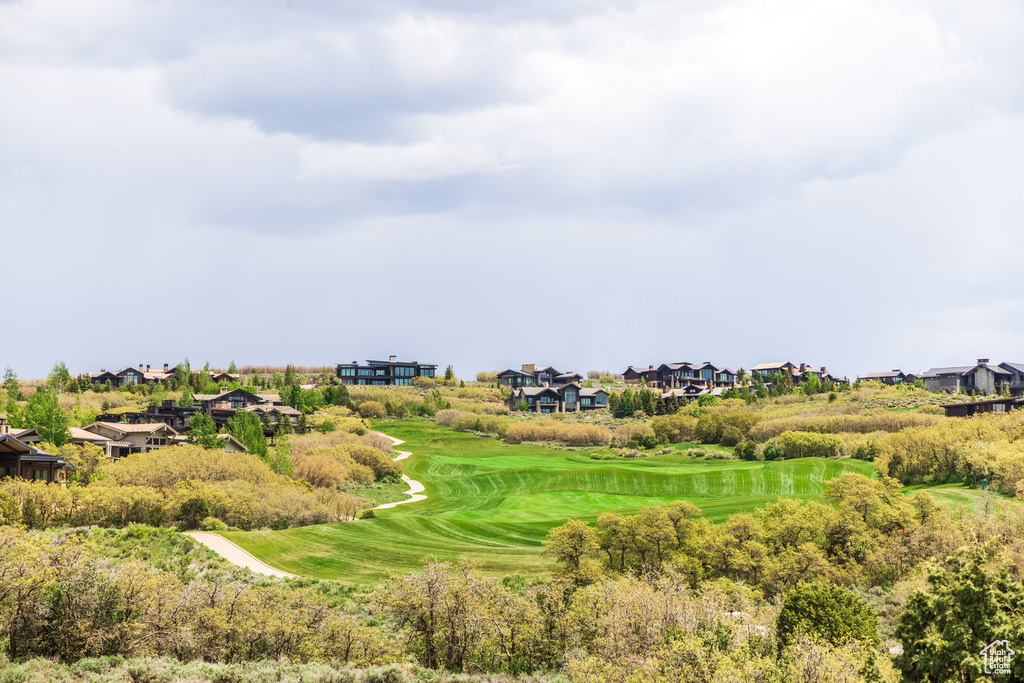 Surrounding community with view of golf course and a residential view