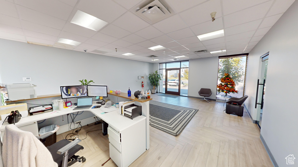 Office featuring a paneled ceiling, french doors, and light parquet flooring