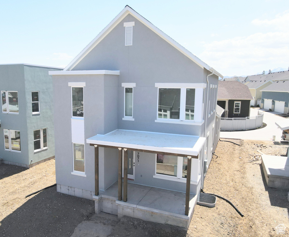View of front of property featuring a patio and stucco siding