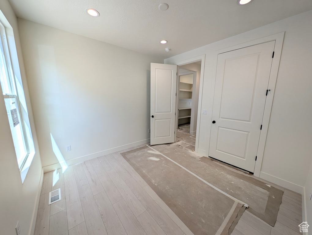 Unfurnished bedroom featuring visible vents, recessed lighting, baseboards, and light wood-style flooring