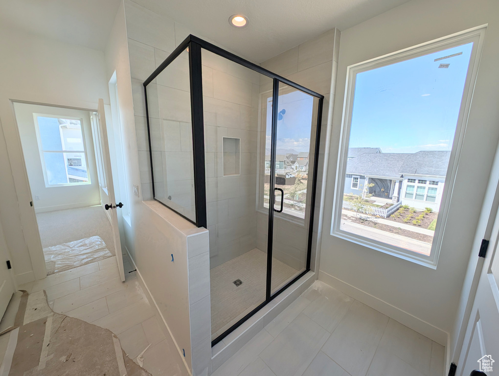 Bathroom featuring baseboards, recessed lighting, and a stall shower