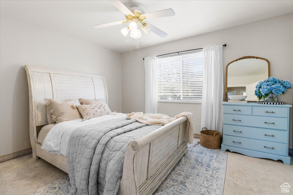 Bedroom featuring light colored carpet and ceiling fan