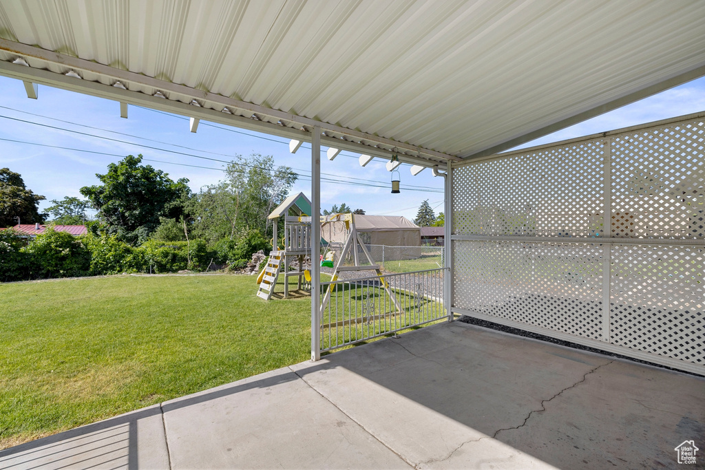 View of patio featuring a playground