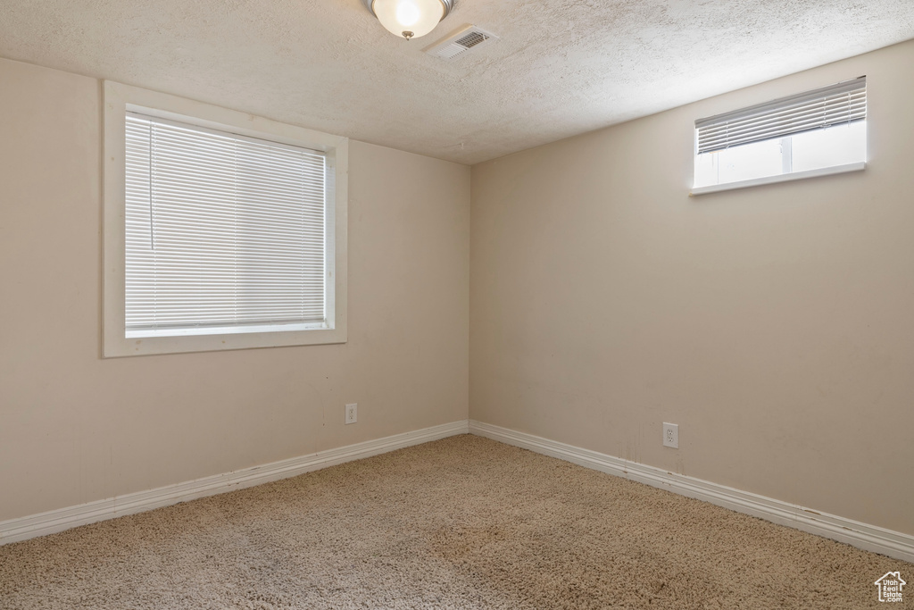 Empty room with a textured ceiling