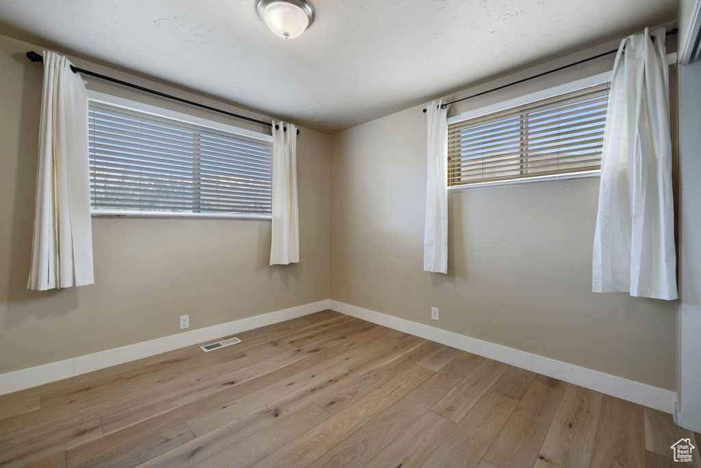 Empty room with light wood-type flooring