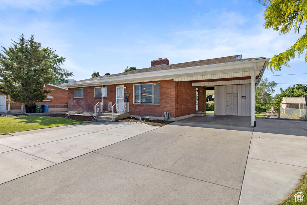 Ranch-style house featuring a carport