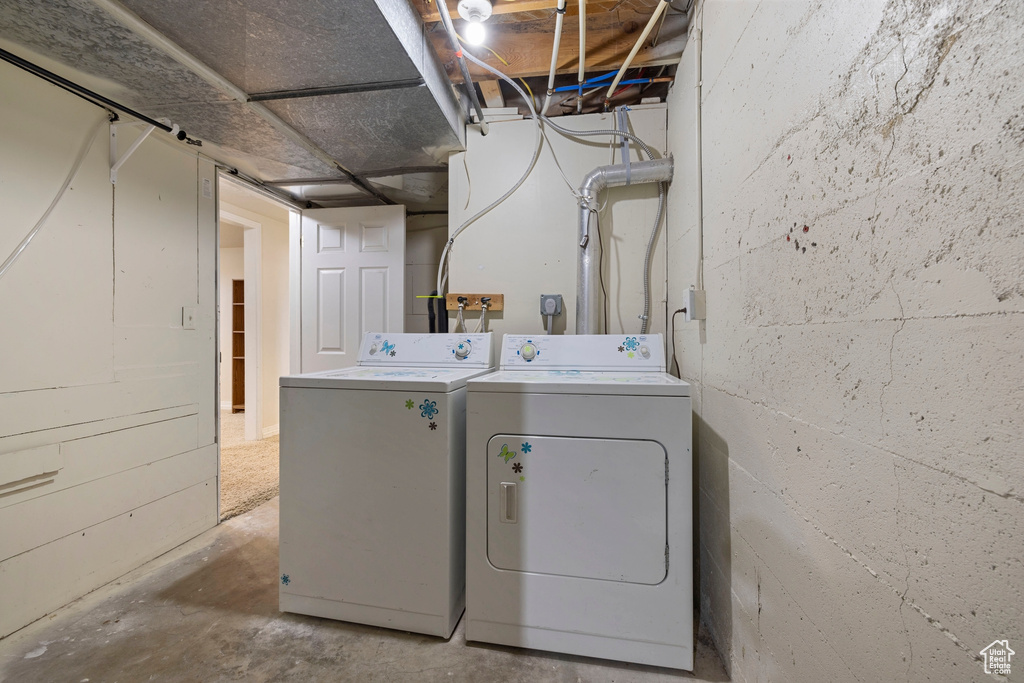 Laundry room with washing machine and clothes dryer