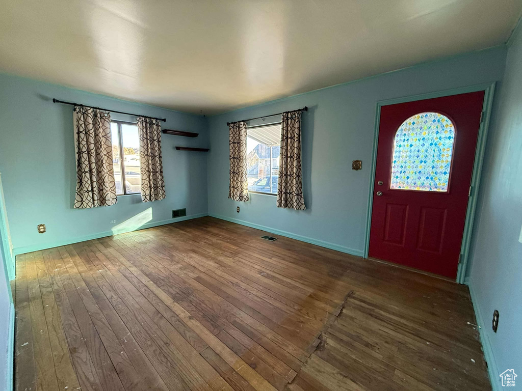 Entrance foyer with hardwood / wood-style floors