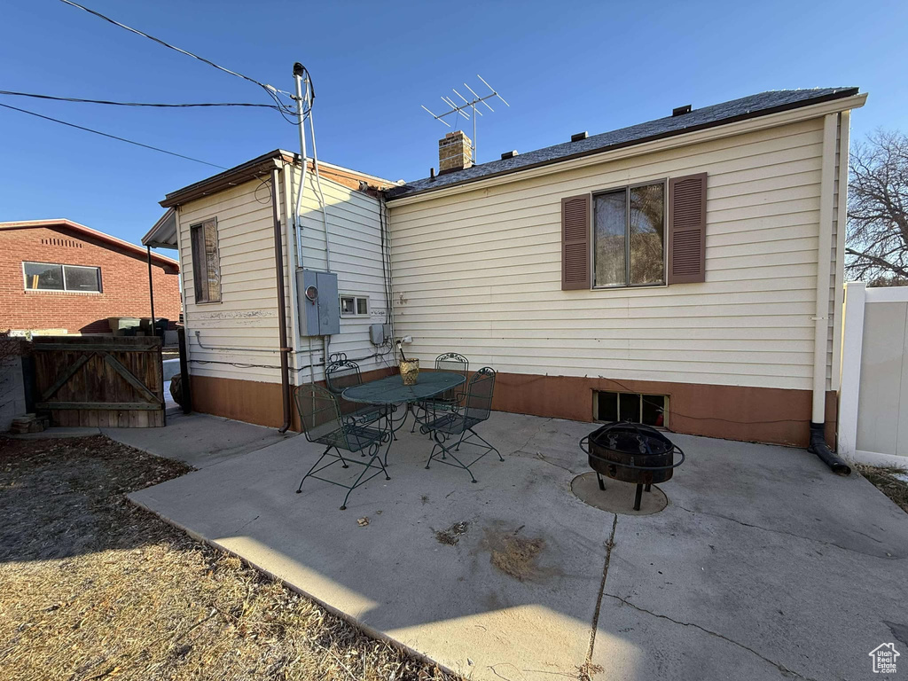 Rear view of house with a fire pit and a patio area