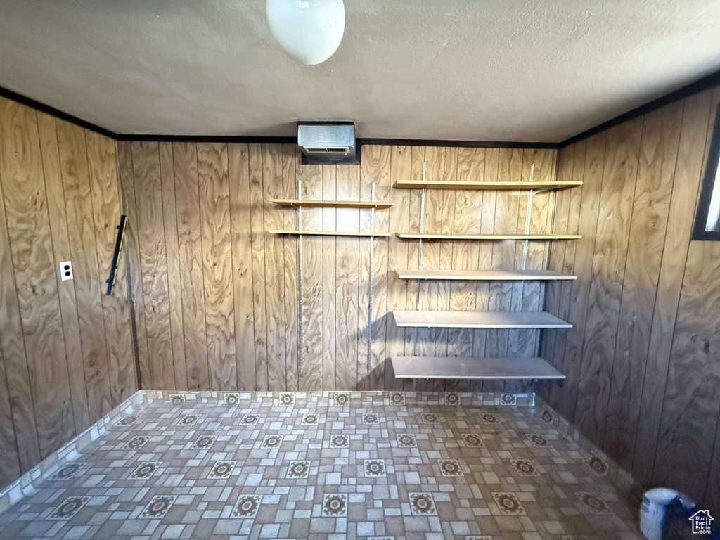 Laundry room with wood walls