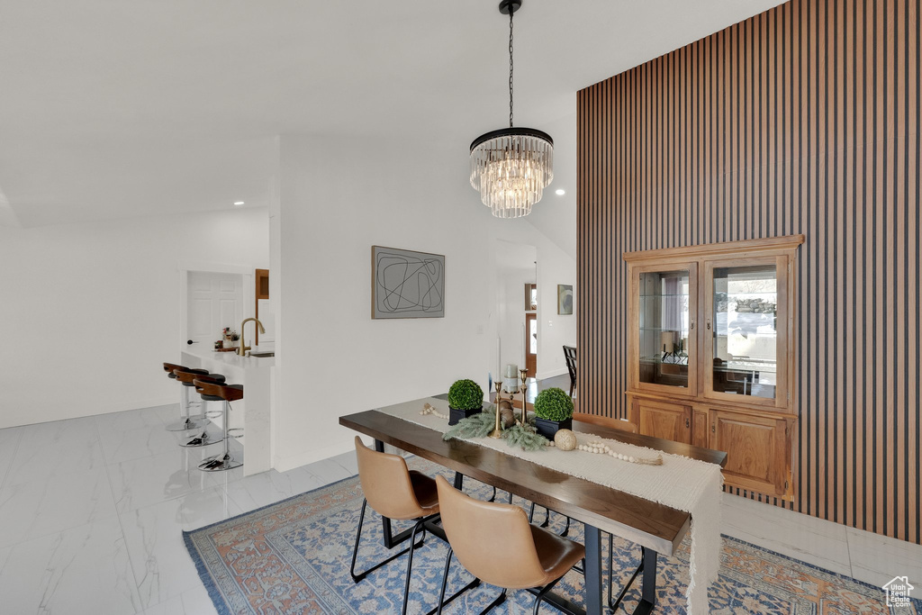 Dining area with high vaulted ceiling and a notable chandelier