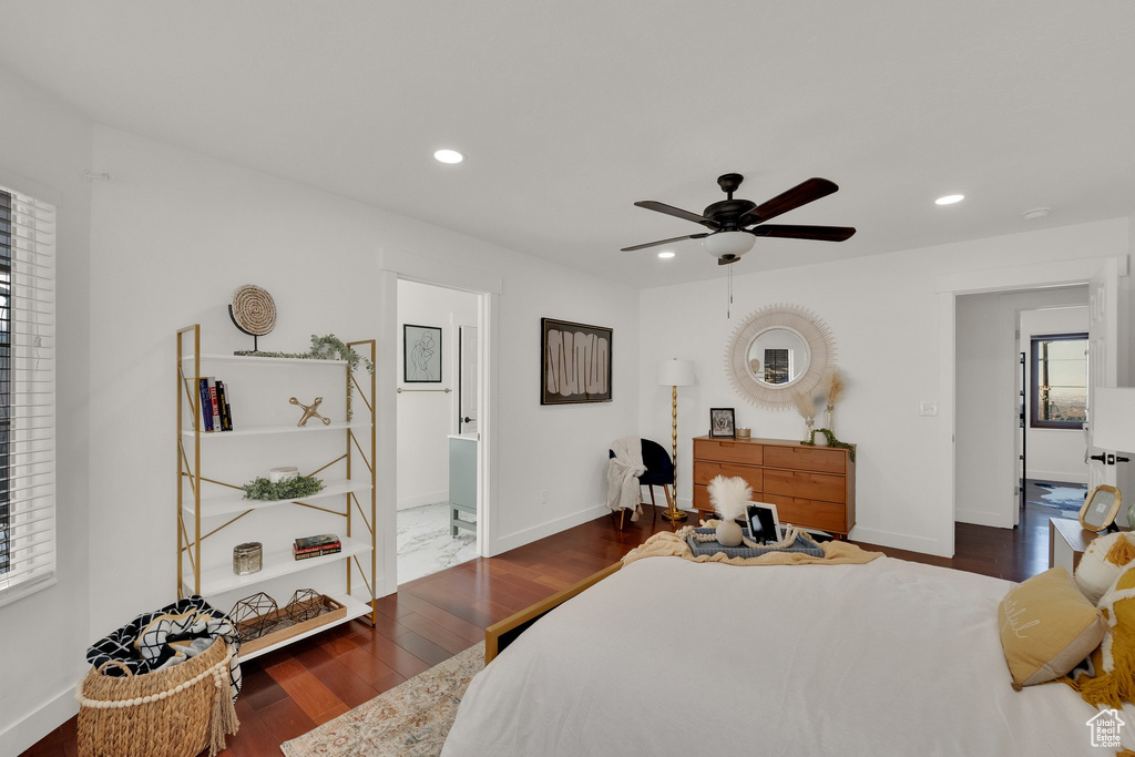 Bedroom with ceiling fan, dark hardwood / wood-style flooring, and ensuite bath