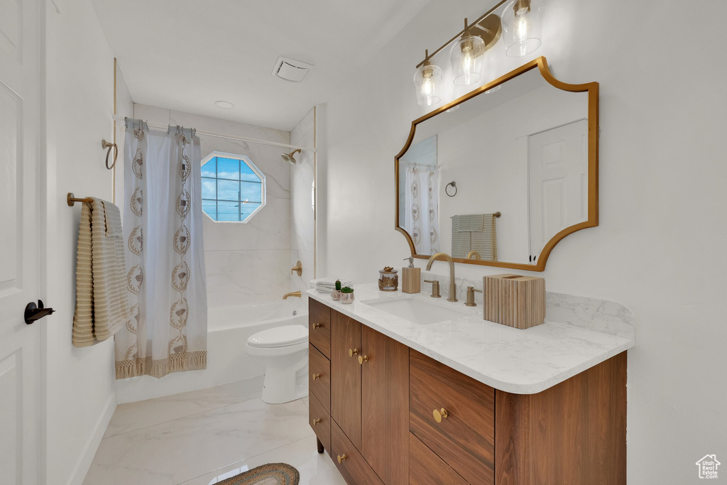 Full bathroom featuring shower / bath combination with curtain, vanity, and toilet