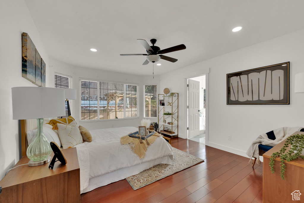 Bedroom featuring connected bathroom, dark hardwood / wood-style floors, and ceiling fan