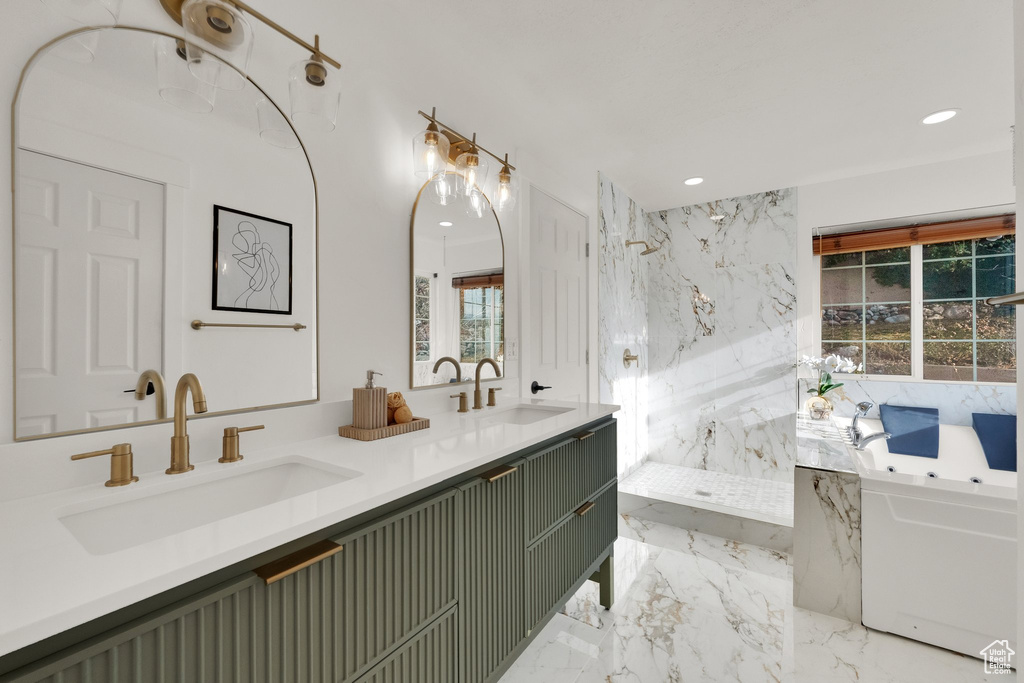 Bathroom featuring vanity and shower with separate bathtub