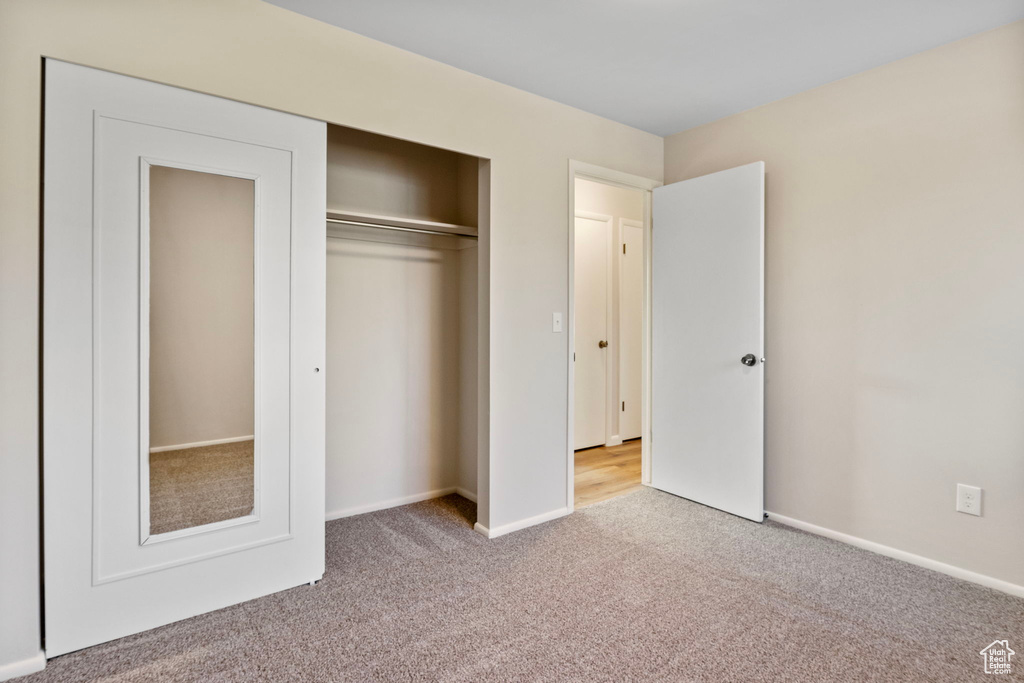 Unfurnished bedroom with carpet floors and a closet