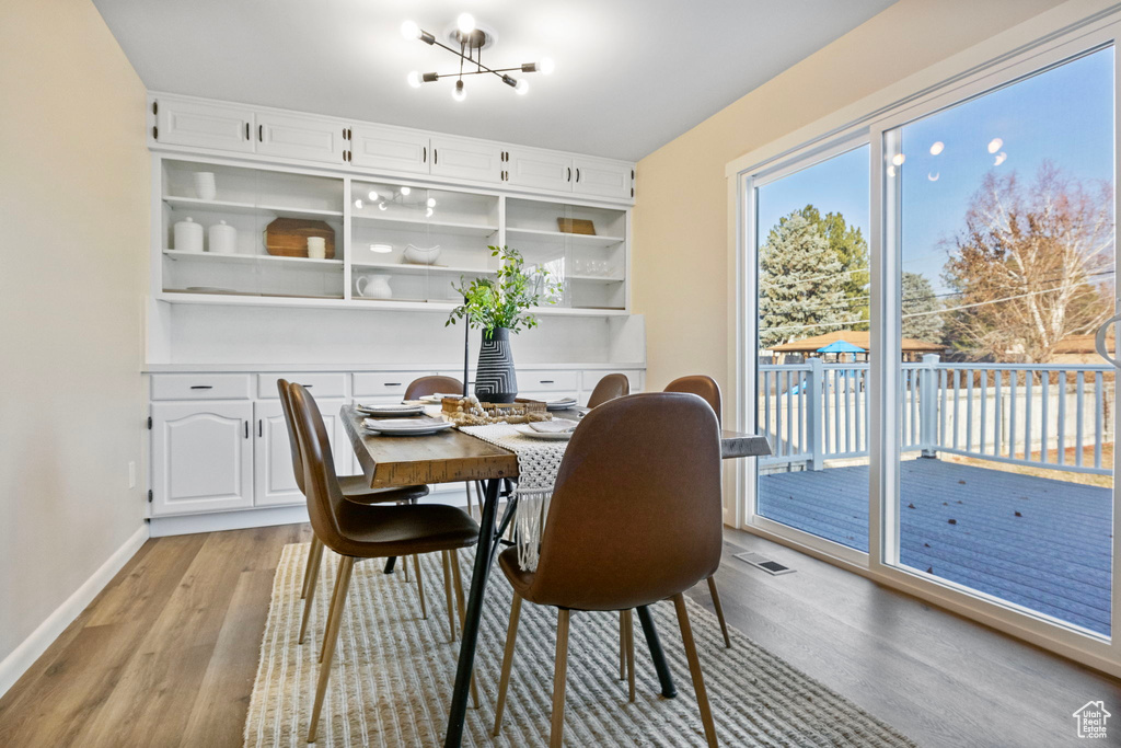 Dining room featuring light hardwood / wood-style floors and a chandelier