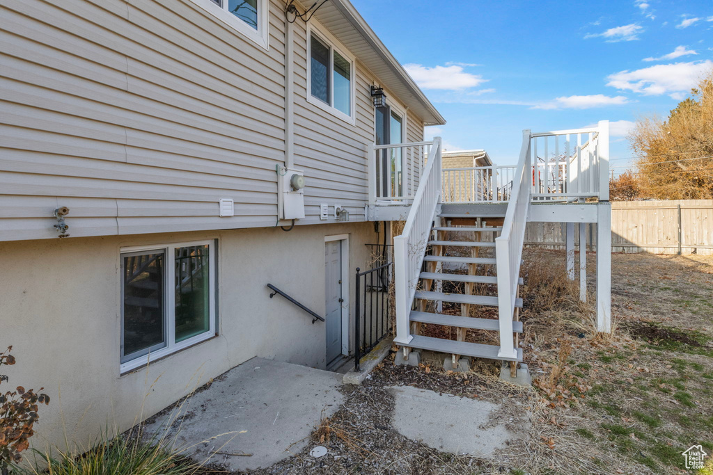 View of side of home with a wooden deck