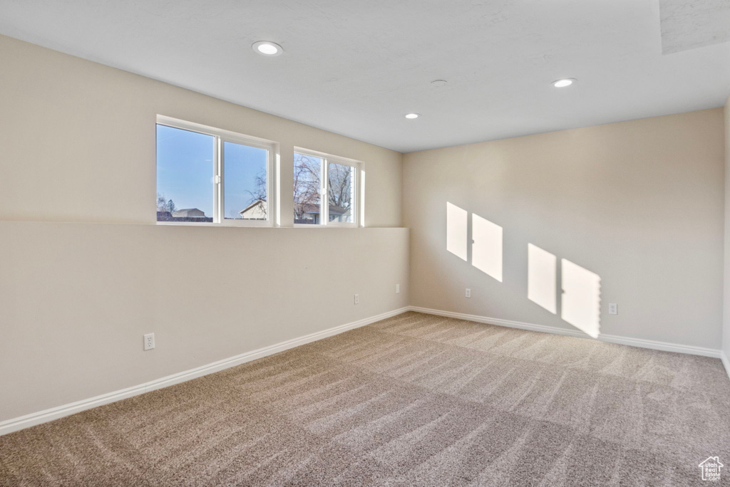 Spare room featuring light carpet